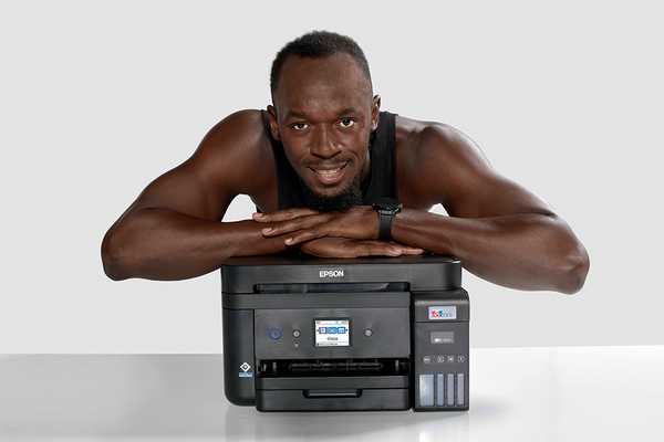 Usain Bolt leaning on Epson EcoTank printer.
